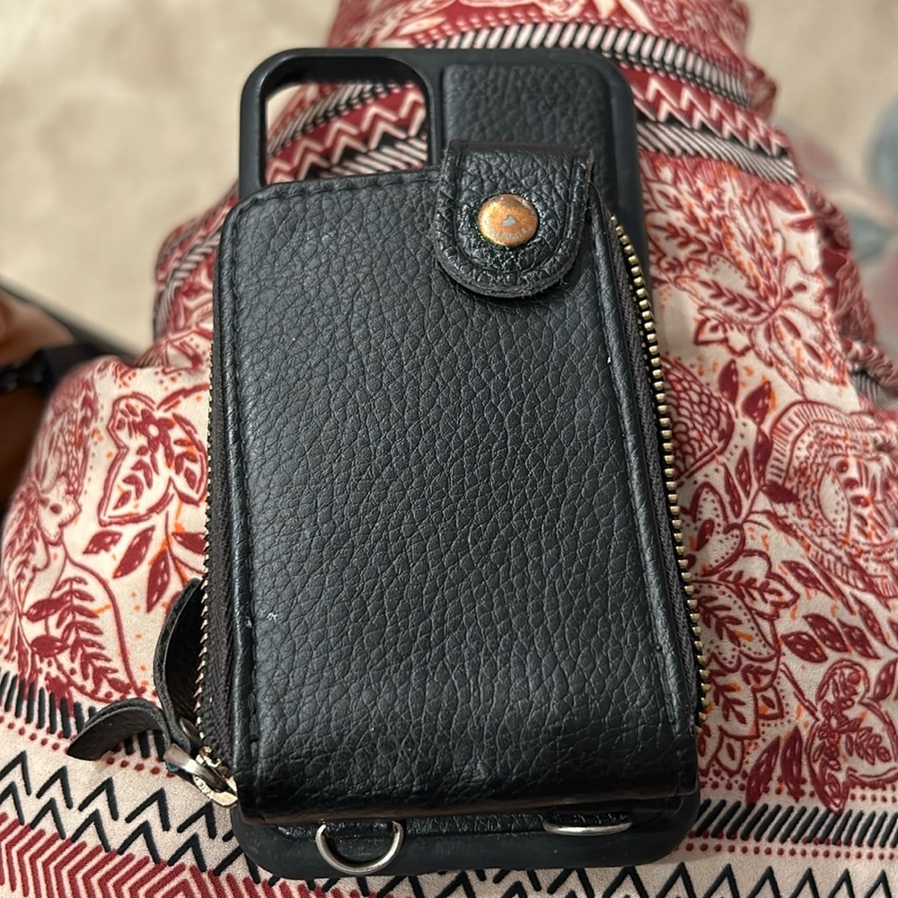 iPhone case and wallet. May be used with multiple straps (not included).
